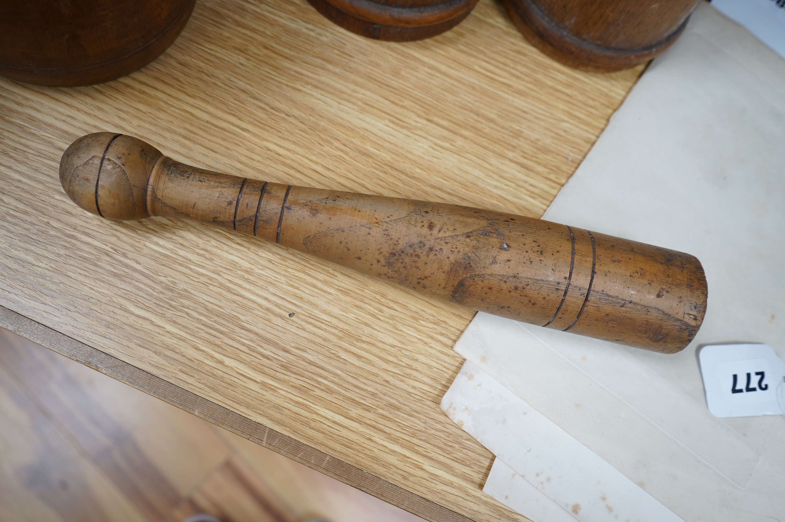 A pair of staved beech flagons, 23cm high, a wooden pestle and mortar, 17.5cm, and turned wood lidded bowl, 18cm (5). Condition - fair